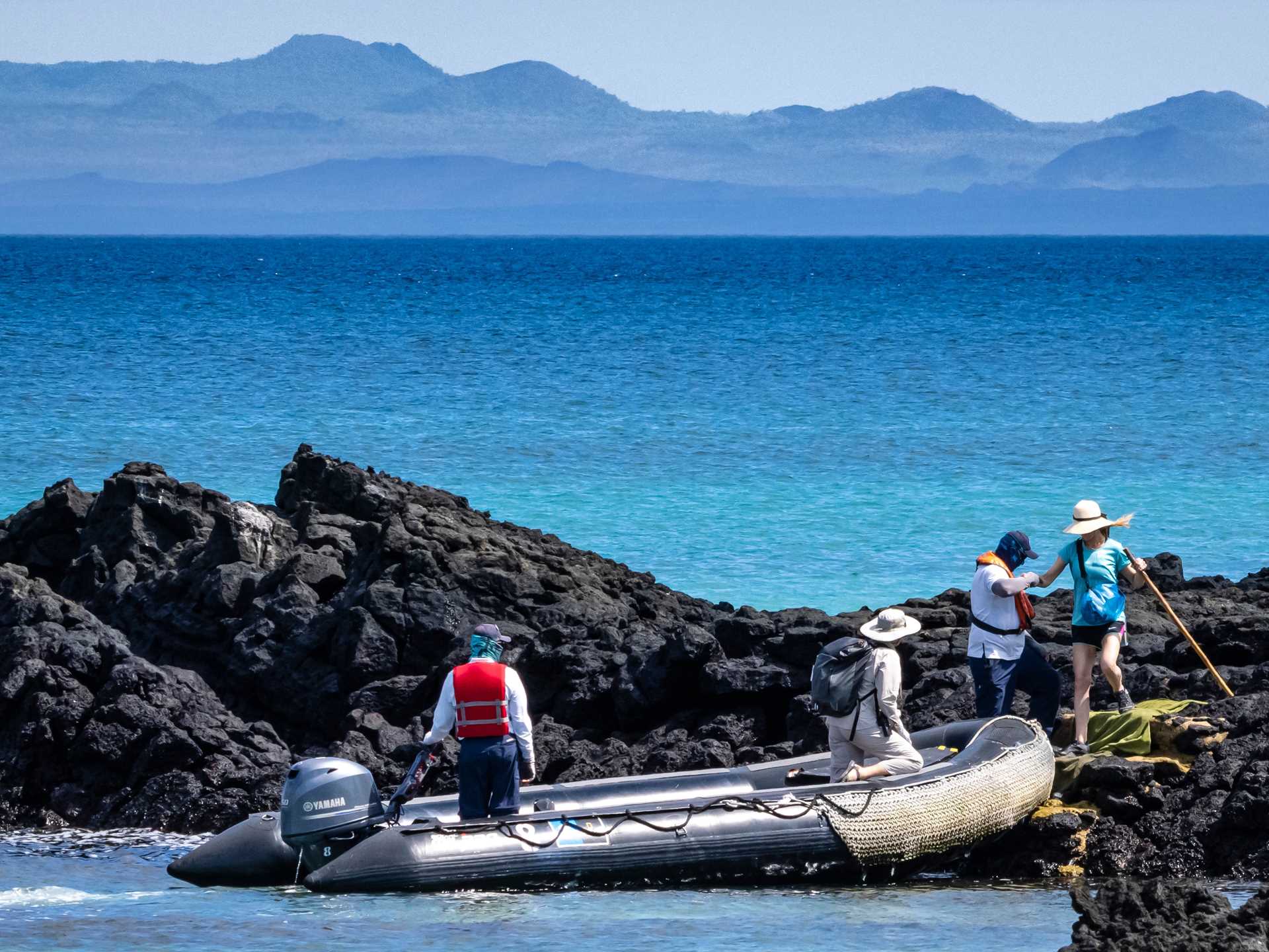 A guest embarks a Zodiac from Cerro Dragon, Santa Cruz Island, Galápagos.