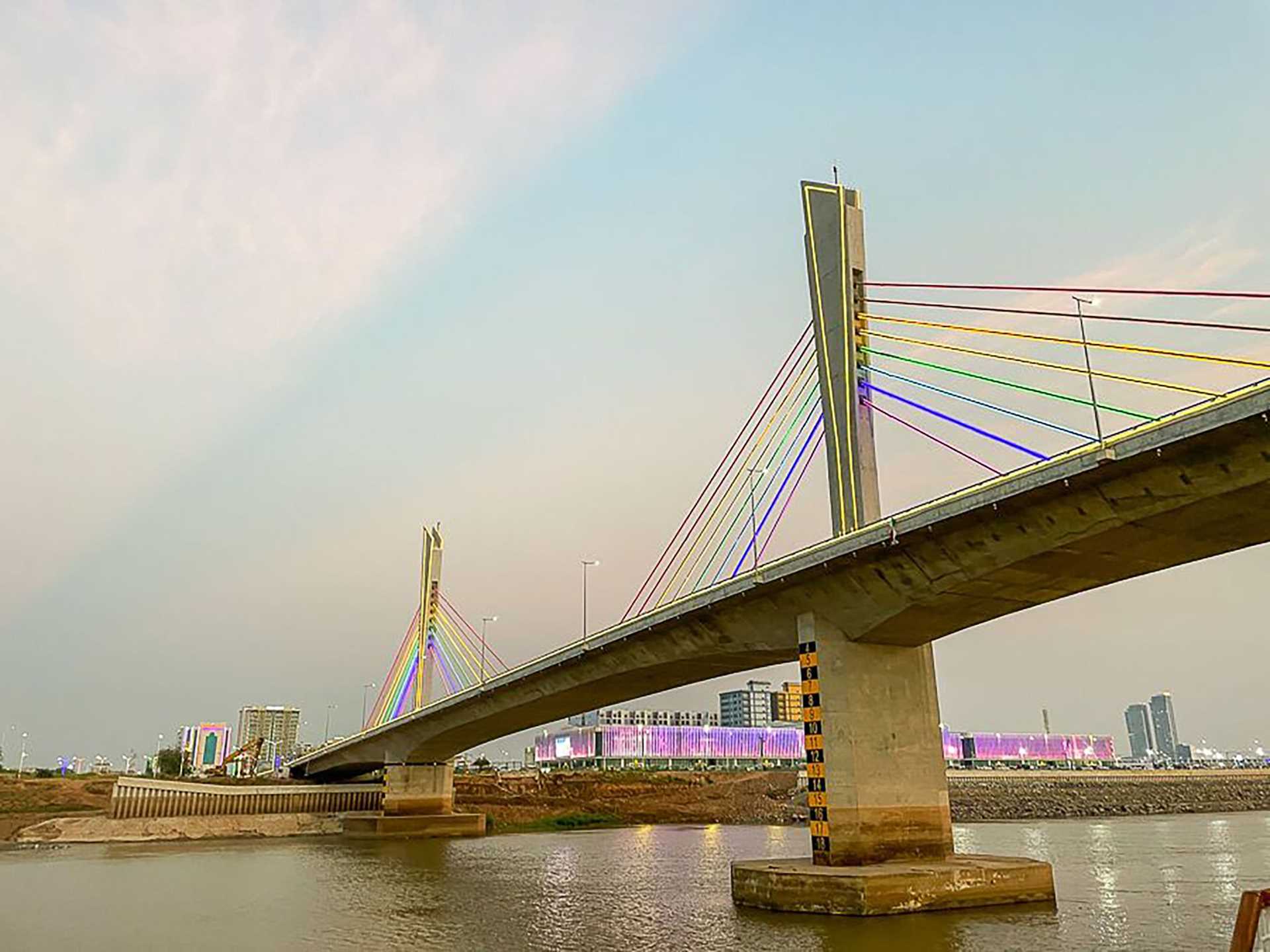 a suspension bridge covered in multicolored lights